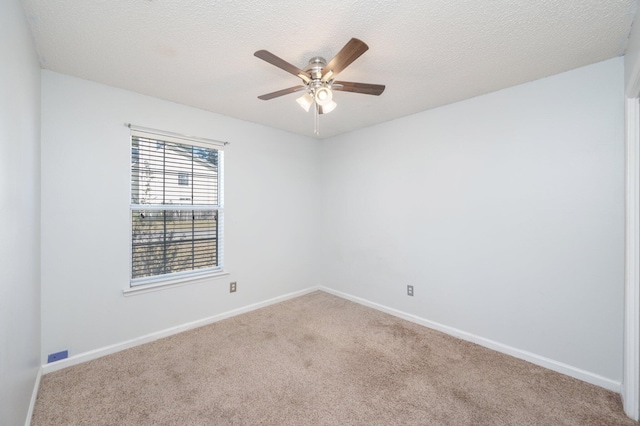 carpeted empty room featuring a textured ceiling and ceiling fan