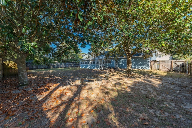 9 Holly Rd, Crestview, FL 32539 - view of yard featuring a sunroom and a fenced backyard