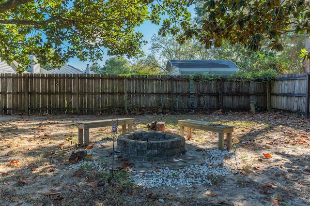 view of yard with a fire pit