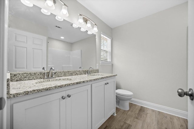 bathroom with vanity, hardwood / wood-style floors, and toilet