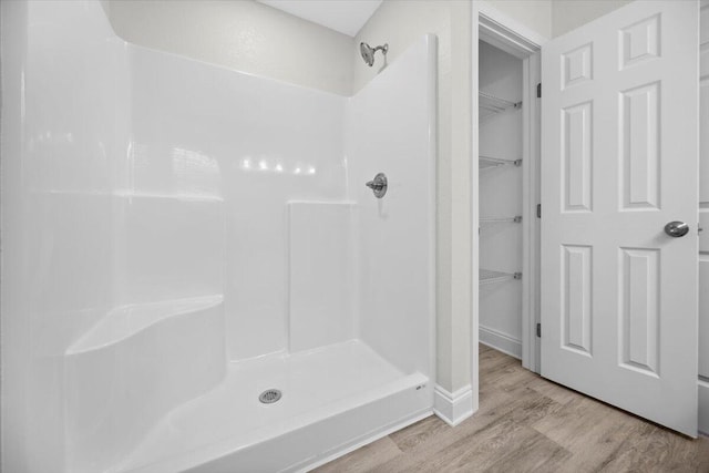 bathroom featuring hardwood / wood-style floors and walk in shower