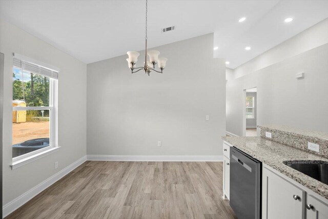 kitchen featuring dishwasher, light wood-type flooring, lofted ceiling, pendant lighting, and white cabinets