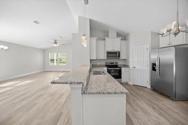 kitchen with kitchen peninsula, hanging light fixtures, sink, vaulted ceiling, and appliances with stainless steel finishes