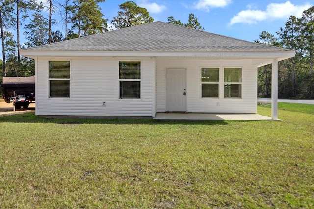 back of house featuring a yard