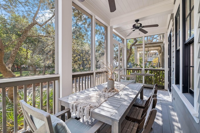 sunroom / solarium with beamed ceiling and ceiling fan