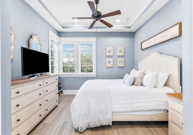 79 Cedar Post Rd, Santa Rosa Beach, FL 32459 - bedroom featuring a raised ceiling, light hardwood / wood-style flooring, ceiling fan, and ornamental molding