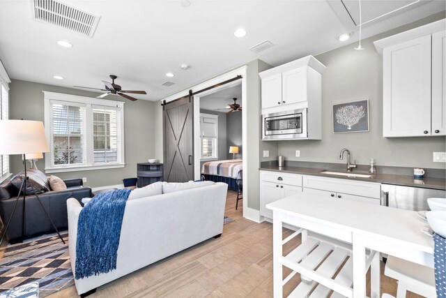 79 Cedar Post Rd, Santa Rosa Beach, FL 32459 - kitchen featuring white cabinetry, stainless steel counters, sink, and stainless steel microwave