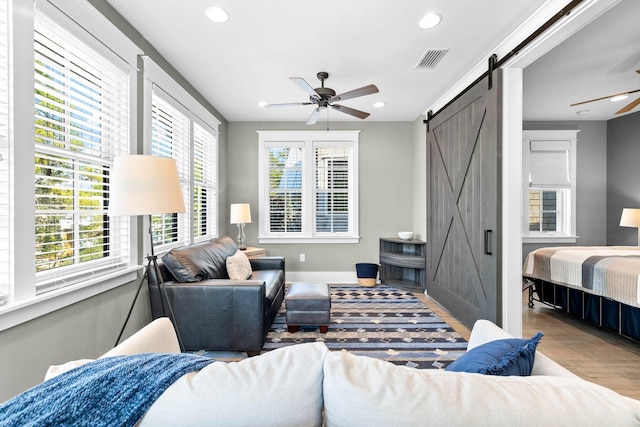 79 Cedar Post Rd, Santa Rosa Beach, FL 32459 - bedroom featuring light wood-type flooring, a barn door, and ceiling fan