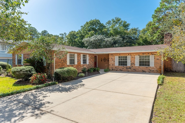 813 Linden Ave, Niceville, FL 32578 - ranch-style home with brick siding, a chimney, and driveway
