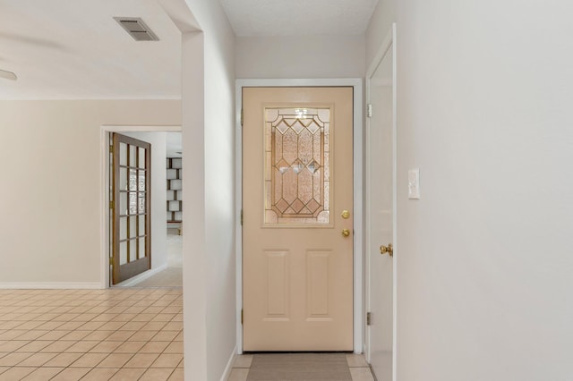 entryway featuring a textured ceiling and light tile patterned flooring