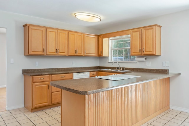 813 Linden Ave, Niceville, FL 32578 - kitchen with white appliances, dark countertops, light tile patterned flooring, a sink, and a peninsula