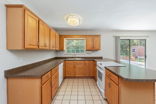 kitchen featuring white appliances, a wealth of natural light, kitchen peninsula, and sink