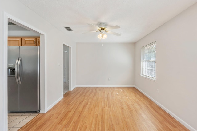 interior space featuring light hardwood / wood-style floors, a textured ceiling, and ceiling fan