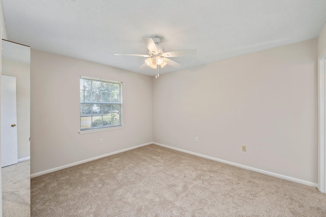 empty room with light carpet, a textured ceiling, and ceiling fan