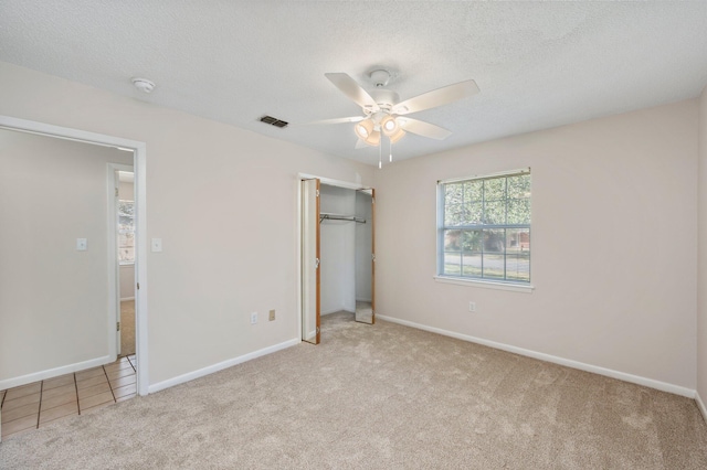 813 Linden Ave, Niceville, FL 32578 - unfurnished bedroom featuring carpet flooring, a closet, baseboards, and a textured ceiling