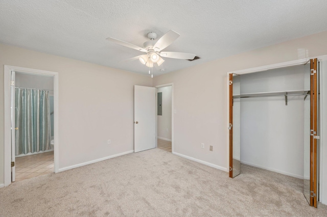 unfurnished bedroom with connected bathroom, ceiling fan, a closet, and light colored carpet