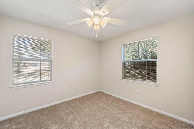 spare room with light carpet, a textured ceiling, and ceiling fan