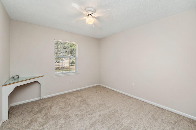 empty room featuring light carpet and ceiling fan