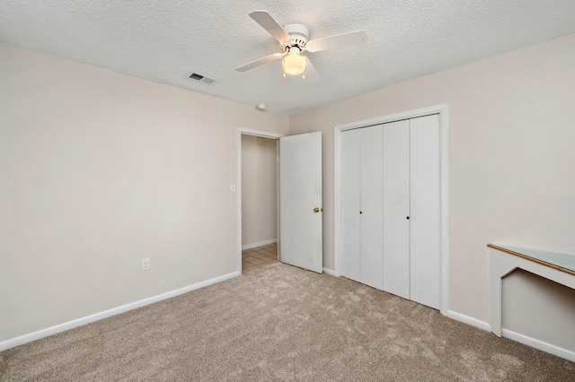 813 Linden Ave, Niceville, FL 32578 - unfurnished bedroom featuring carpet floors, a closet, baseboards, a textured ceiling, and ceiling fan
