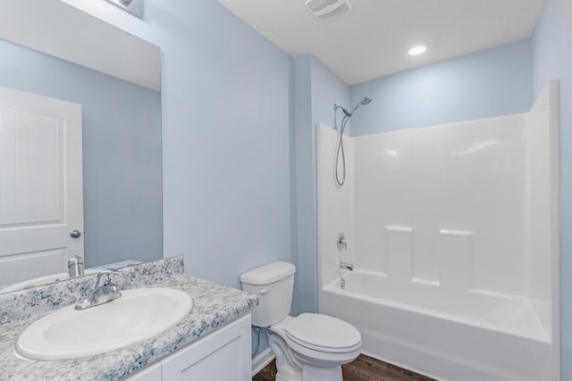 full bathroom with hardwood / wood-style flooring, vanity, toilet, and bathing tub / shower combination