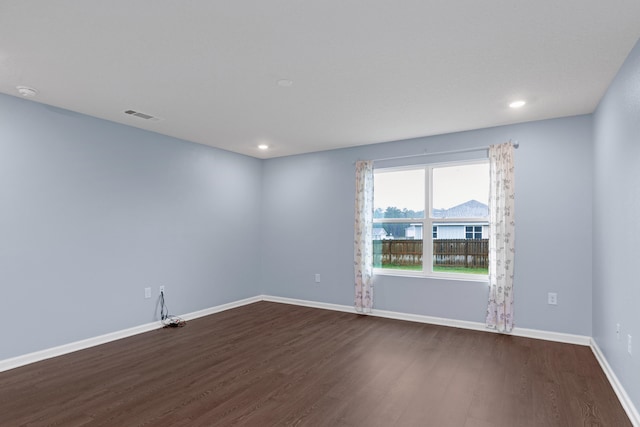 spare room with hardwood / wood-style floors