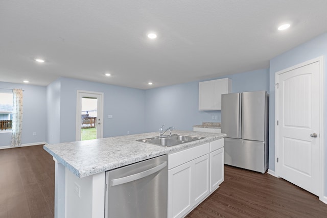 kitchen with white cabinetry, plenty of natural light, a kitchen island with sink, and appliances with stainless steel finishes