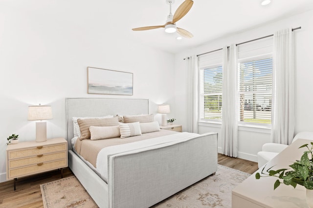 bedroom featuring light wood-type flooring and ceiling fan