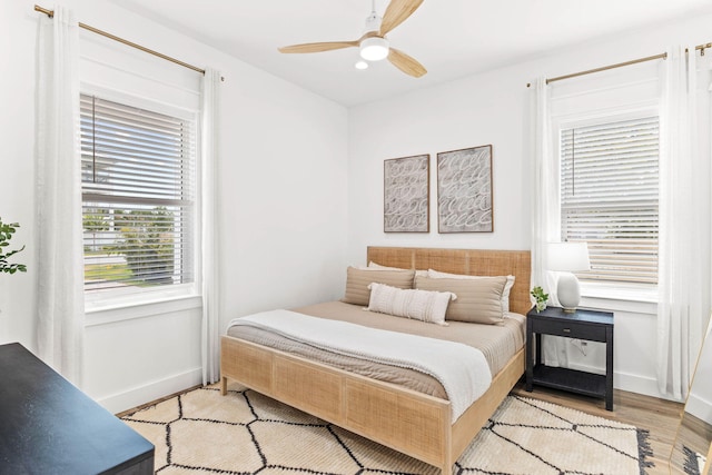 bedroom with light hardwood / wood-style floors and ceiling fan