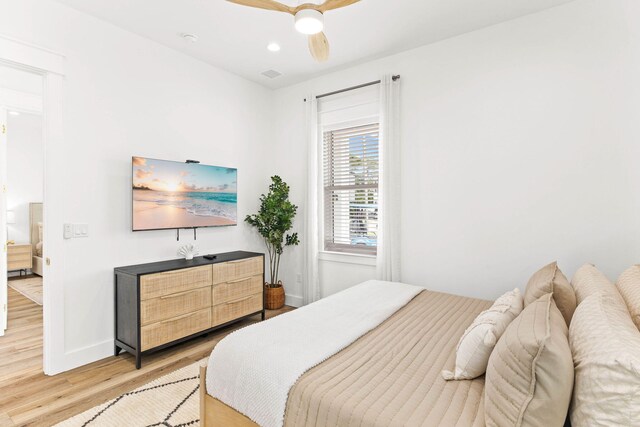 bedroom with hardwood / wood-style floors and ceiling fan