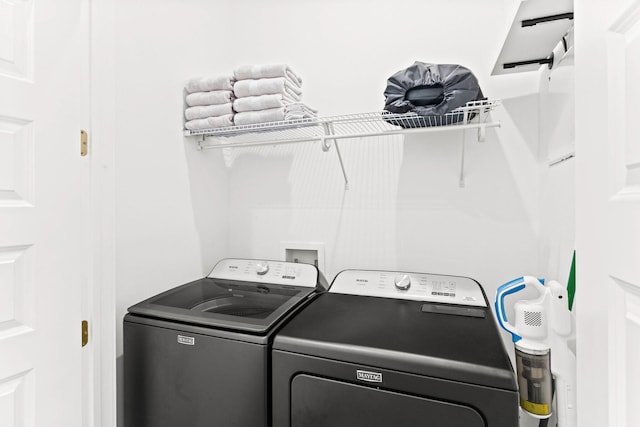 clothes washing area featuring washer and clothes dryer