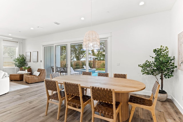 dining space featuring light wood-type flooring