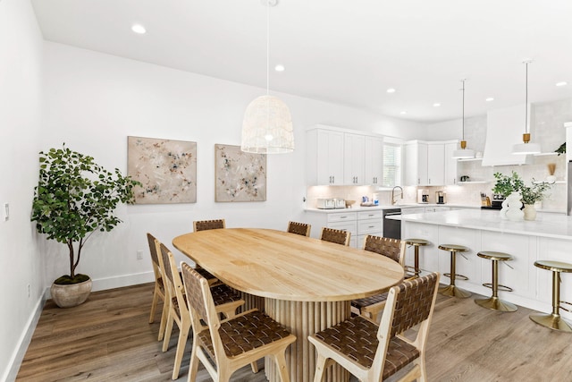 dining room with light hardwood / wood-style flooring and sink