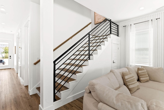 stairs featuring wood-type flooring