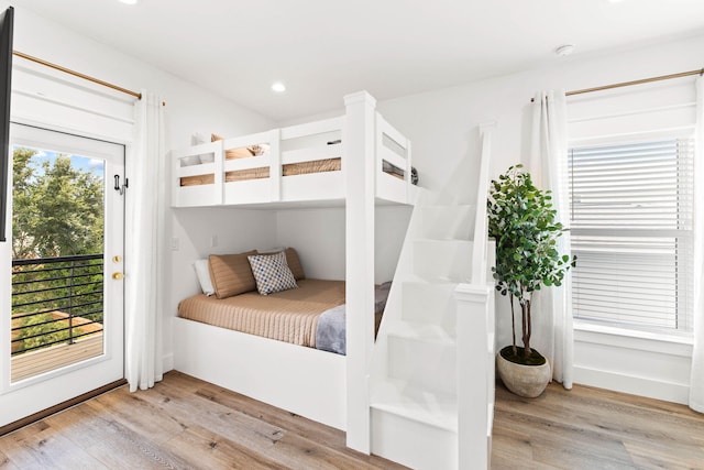 bedroom with access to outside and light wood-type flooring