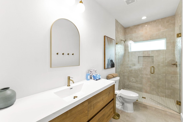 bathroom with vanity, tile patterned floors, toilet, and a shower with door