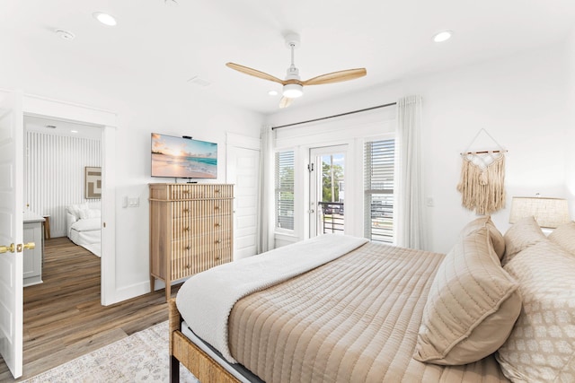 bedroom with access to exterior, hardwood / wood-style flooring, and ceiling fan