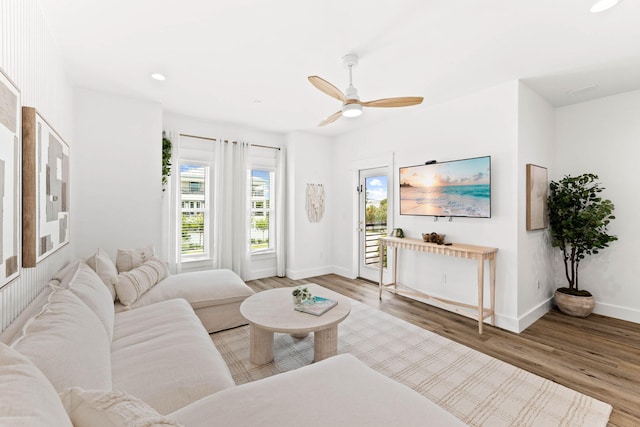 living room featuring hardwood / wood-style flooring and ceiling fan