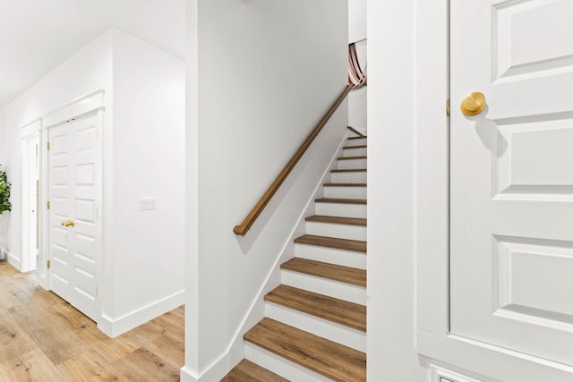 stairs featuring hardwood / wood-style flooring