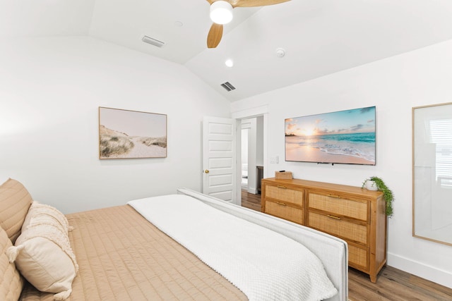 bedroom with hardwood / wood-style flooring, ceiling fan, and vaulted ceiling