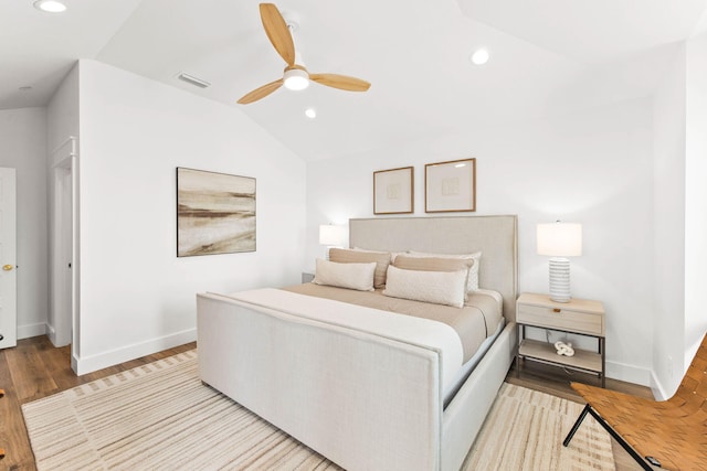 bedroom with vaulted ceiling, ceiling fan, and light hardwood / wood-style flooring