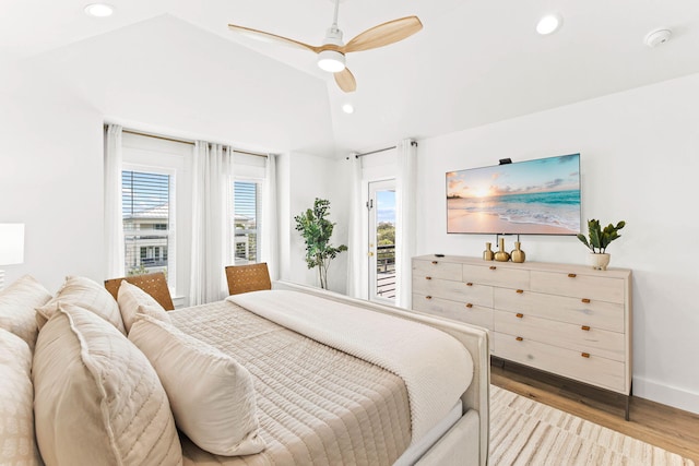 bedroom with light wood-type flooring, lofted ceiling, ceiling fan, and access to exterior