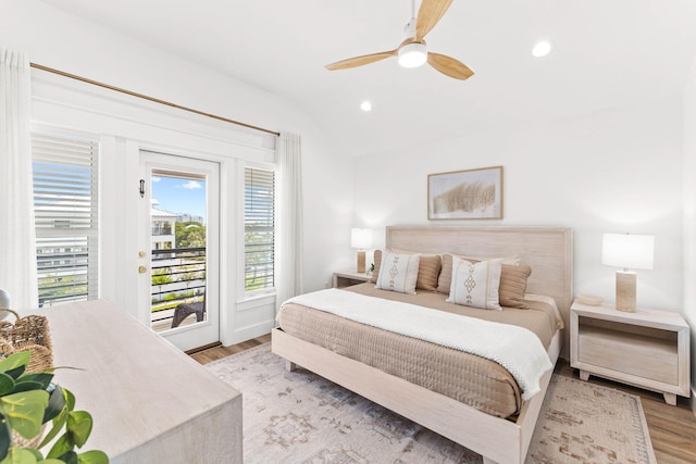 bedroom with ceiling fan, vaulted ceiling, light hardwood / wood-style floors, and access to exterior