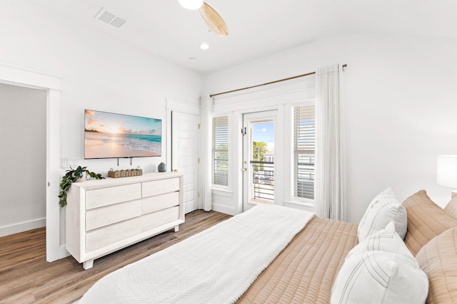 bedroom with hardwood / wood-style floors, ceiling fan, and access to outside