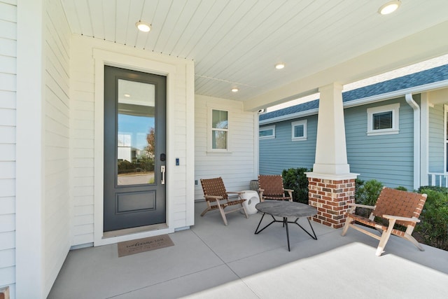 view of exterior entry with covered porch