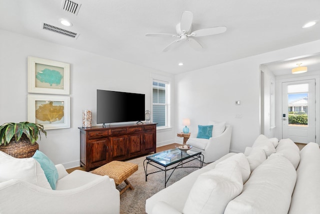 living room with ceiling fan and hardwood / wood-style flooring