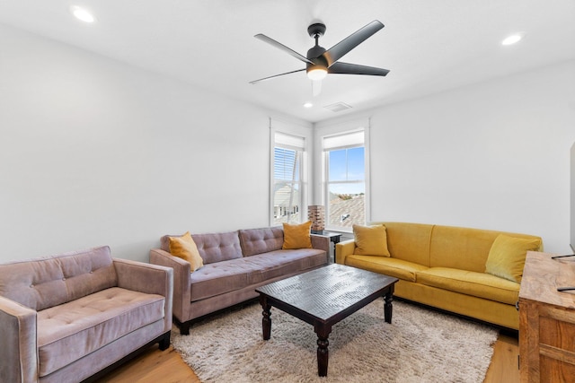 living room featuring ceiling fan and light hardwood / wood-style flooring