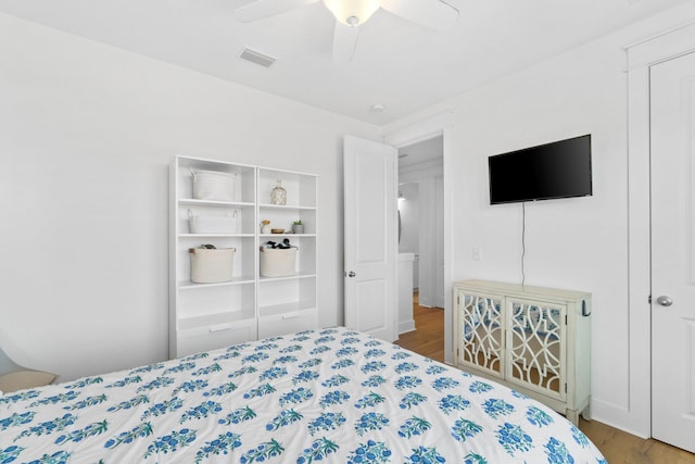 bedroom with ceiling fan, wood-type flooring, and a closet