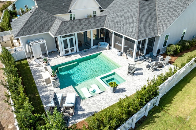 view of pool featuring french doors, an outdoor fire pit, a patio, and a sunroom