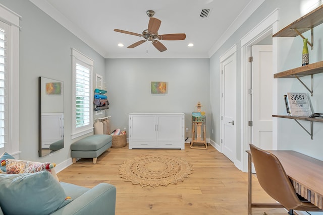 sitting room with light hardwood / wood-style floors, ornamental molding, and ceiling fan