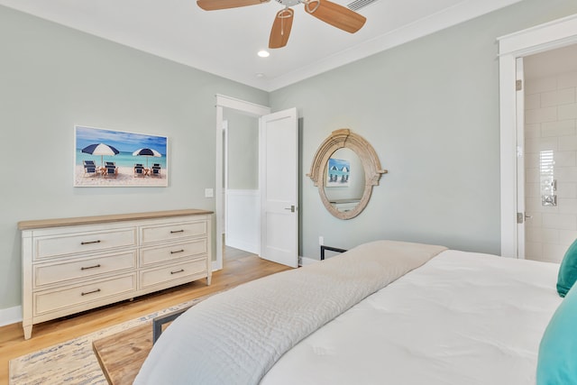 bedroom with connected bathroom, light hardwood / wood-style flooring, and ceiling fan